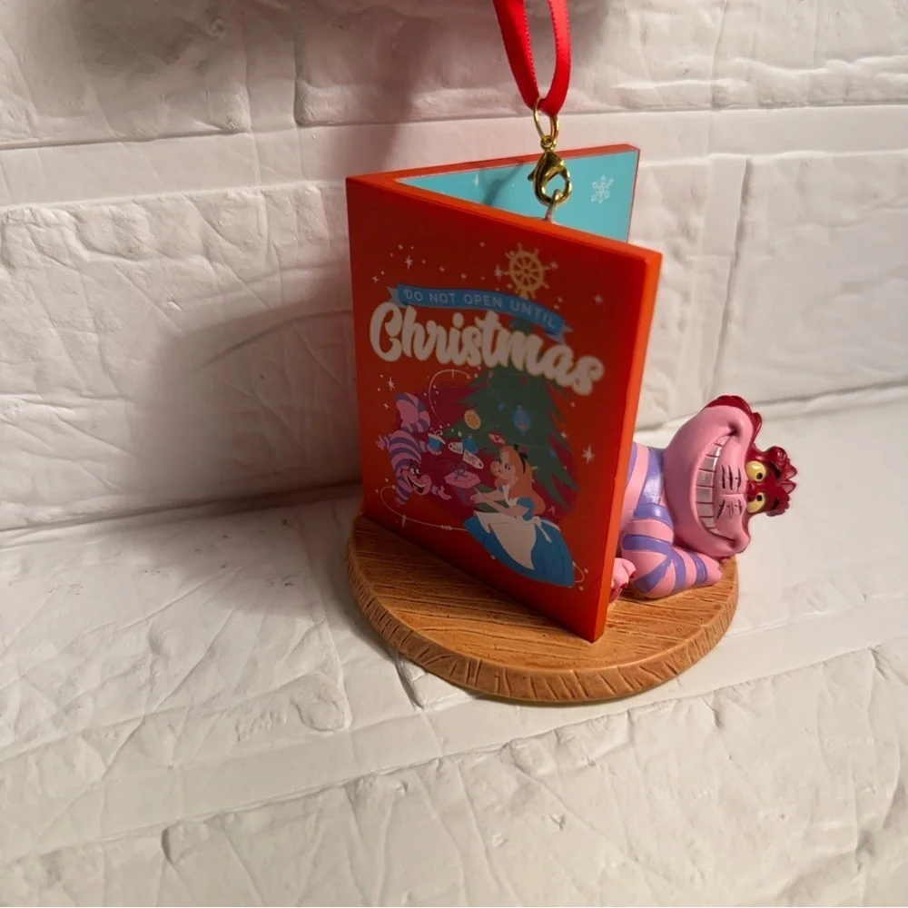 New Disney Cheshire Cat Christmas Ornament in Book Red and Purple